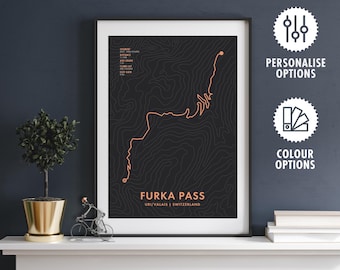 May include: Framed black and orange Furka Pass map art print. The print features a detailed topographic design of the Furka Pass in Switzerland. The text "Furka Pass" and "Uri/Valais | Switzerland" are displayed at the bottom of the print.