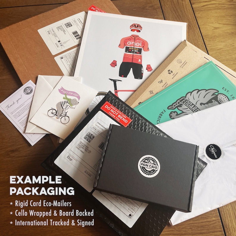 May include: Example of packaging for an art print. The print is wrapped in cellophane and backed by a cardboard sheet. It is placed inside a rigid cardboard mailer with the text "Do Not Bend" printed on it. The mailer is placed inside a larger cardboard box with the text "Pain Cave Prints" on it. The box is wrapped in white tissue paper and placed inside a larger cardboard box with the text "Edoard Fabric" on it.