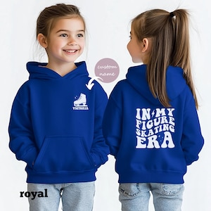 May include: Royal blue hooded sweatshirt with a white figure skate graphic on the front and the text "In My Figure Skating Era" on the back. The sweatshirt is available in youth sizes.
