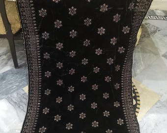 May include: Black velvet shawl with a silver embroidered floral pattern. The shawl has a decorative border with silver beads.