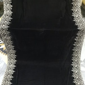 May include: A black velvet shawl with a white embroidered border. The embroidery features floral designs.
