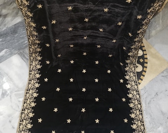 May include: Black velvet shawl with gold embroidery. The shawl features a floral design along the edges and a scattered star pattern throughout.