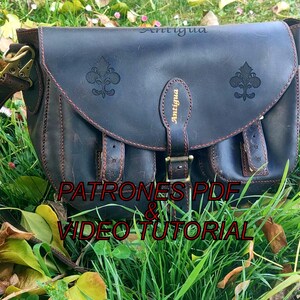 May include: A dark brown leather satchel bag with a flap closure, adorned with fleur-de-lis emblems and the word "Antigua". The bag features a long adjustable strap and brass-colored hardware. The text "PATRONES PDF & VIDEO TUTORIAL" is visible.