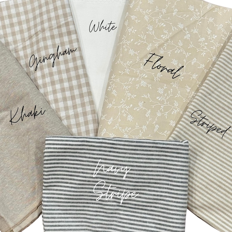 May include: A collection of fabric swatches featuring various patterns and colors. The set includes a solid khaki fabric, a beige and white gingham check, a solid white fabric, a beige floral print, a beige striped fabric, and a navy blue striped fabric.