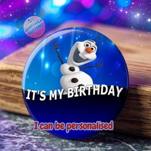 May include: A round button with a blue and white background featuring Olaf from Frozen. The button has the text "IT'S MY BIRTHDAY" and "I can be personalised". A smaller button with "Boardwalk Buttons" is in the upper left.
