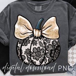 May include: Dark gray sweatshirt featuring a pumpkin design. The pumpkin has a cream-colored base with black floral lace detailing. A large gold glitter bow sits atop the pumpkin, with a teal stem. The words "digital download PNG" are written in white script.
