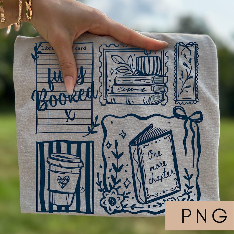 May include: A light beige t-shirt with a dark blue graphic design featuring book-themed illustrations. The design includes a coffee cup, a library card, a stack of books, and the text "fully booked" and "One more chapter".