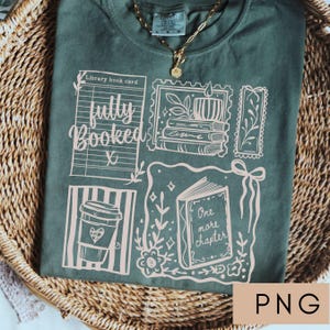 May include: Green t-shirt with a graphic design featuring book-themed illustrations and the words "fully booked" and "one more chapter." The design includes a coffee cup, a library book card, and postage stamp-style images. A gold necklace is visible.