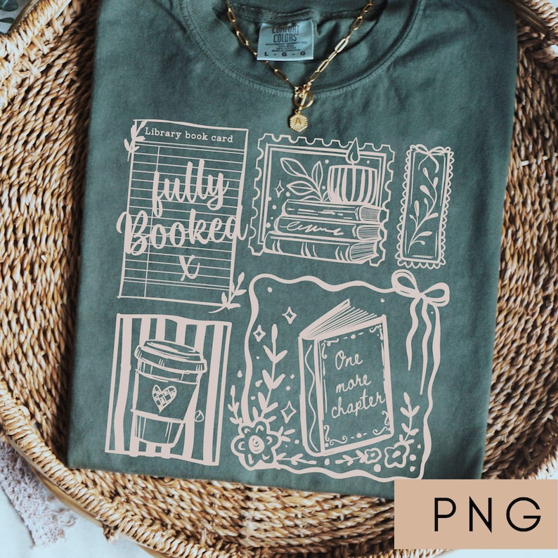 May include: Green t-shirt with a graphic design featuring book-themed illustrations and the words "fully booked" and "one more chapter." The design includes a coffee cup, a library book card, and postage stamp-style images. A gold necklace is visible.