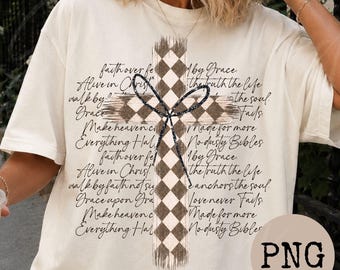 May include: An off-white short-sleeve t-shirt featuring a large central cross with a brown and white checkered pattern. A black glittery bow is layered over the cross. The background text includes phrases like faith over fear and alive in Christ.