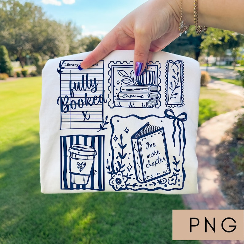 May include: Cream-colored t-shirt with a navy blue graphic design featuring a coffee cup, books, and the words "fully booked" and "one more chapter." The design includes a library card and postage stamp illustrations.