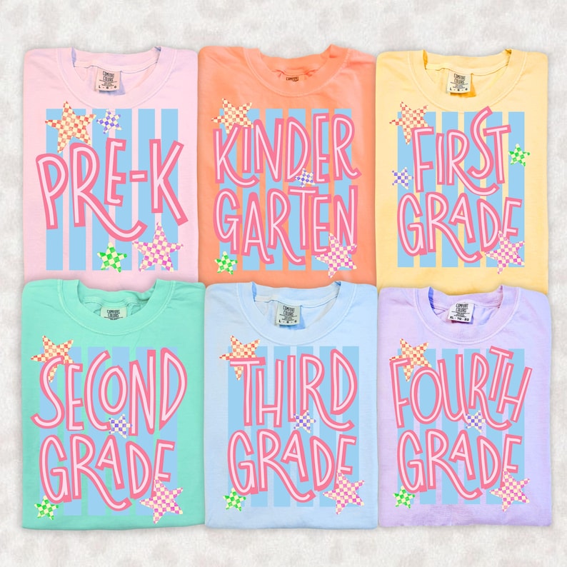 May include: Six t-shirts in pastel colors featuring vertical light blue stripes and pink text reading Pre-K, Kindergarten, First Grade, Second Grade, Third Grade, and Fourth Grade. Each shirt is decorated with small, colorful checkered stars.