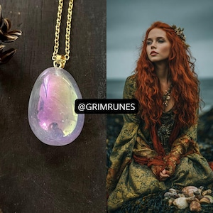 May include: A teardrop-shaped iridescent pendant on a gold-toned chain. The pendant displays a pearlescent sheen with hints of pink and purple. The text @GRIMRUNES is visible in the centre. Beside it, a person with long red hair wears a patterned dress.