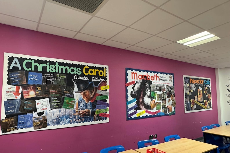 May include: A classroom with pink walls and three bulletin boards. The bulletin boards are decorated with colorful paper and images. The boards are titled "A Christmas Carol", "Macbeth", and "An Inspector Calls".