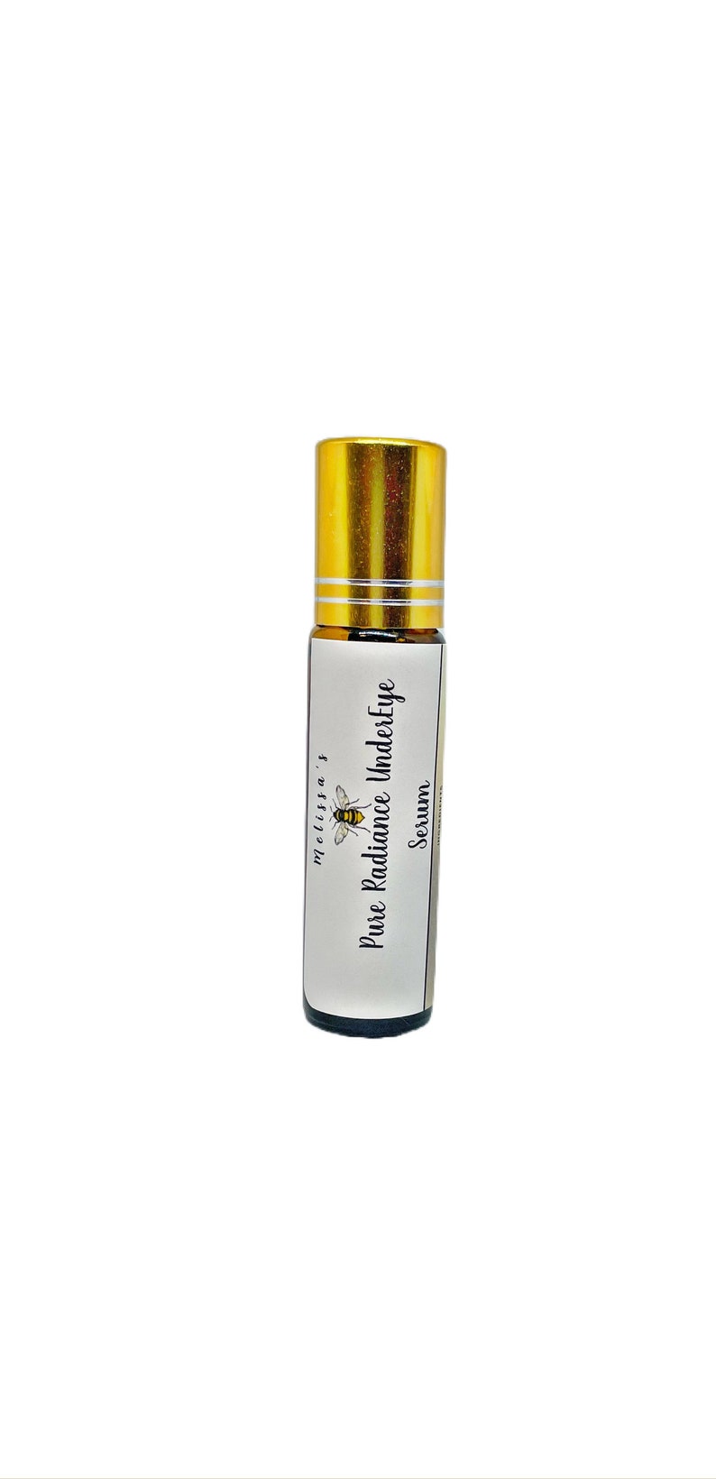 K&ouml;nnte beinhalten: Eine kleine, durchsichtige Glasflasche mit goldener Kappe und einem wei&szlig;en Etikett. Das Etikett tr&auml;gt die Aufschrift "melissa's Pure Radiance Undereye Serum". Auf dem Etikett befindet sich eine kleine Bienenillustration.