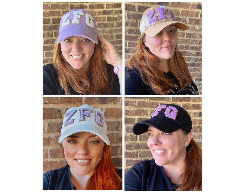 May include: Four different views of a baseball cap with the letters "ZFG" in purple felt on the front of the cap. The caps are in different colors: purple, beige, white, and black.