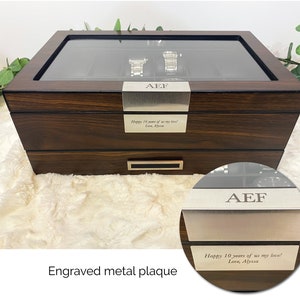Close up of custom engraved message on wood and glass watch organizer box for men. Elegant watch display case for men with walnut wood, glass, and stainless steel accents. Mens accessory and watch jewelry box. Personalized 12 watch display case men