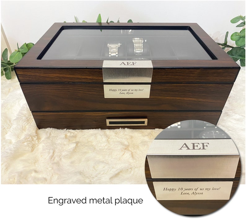 Close up of custom engraved message on wood and glass watch organizer box for men. Elegant watch display case for men with walnut wood, glass, and stainless steel accents. Mens accessory and watch jewelry box. Personalized 12 watch display case men