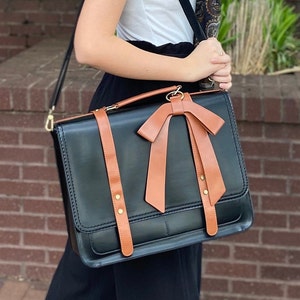 Young woman modeling black and brown laptop bag. Feminine laptop bag with bow. Professional computer work bag for woman laptop compartment. Monogrammed briefcase for woman. Custom graduation gift for daughter. New job gift for woman. Promotion gift