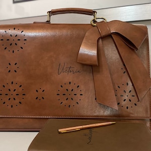 Brown leather laptop bag for women with bow and eyelet cutout detail. Custom laser engraved leather laptop bag for women. Personalized vegan leather satchel. New job gift for woman. Graduation gift for woman. Custom gift for professional woman.