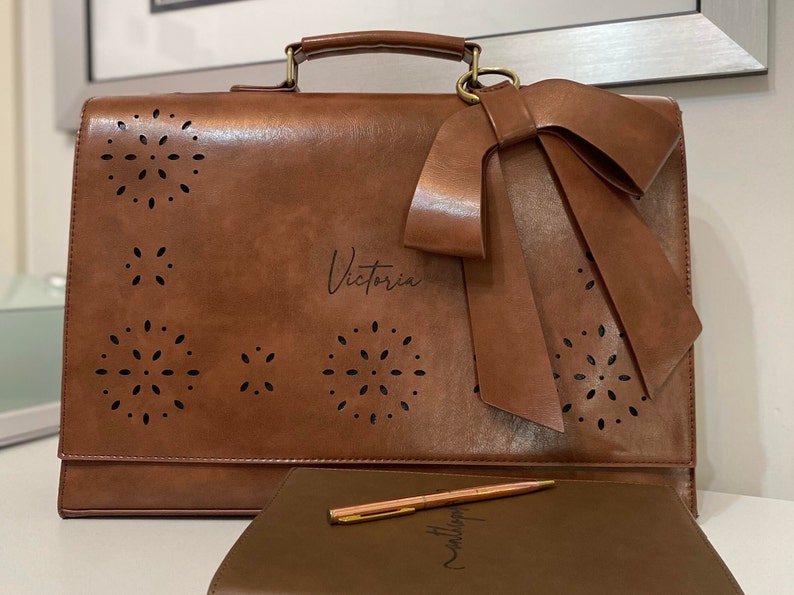 Brown leather laptop bag for women with bow and eyelet cutout detail. Custom laser engraved leather laptop bag for women. Personalized vegan leather satchel. New job gift for woman. Graduation gift for woman. Custom gift for professional woman.