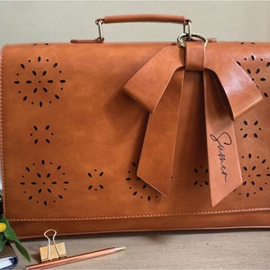 Tan leather laptop bag for women with bow and eyelet cutout detail. Custom leather laptop bag for women. Personalized vegan leather satchel for women. New job gift for woman. Graduation gift for woman. Custom gift for professional woman.