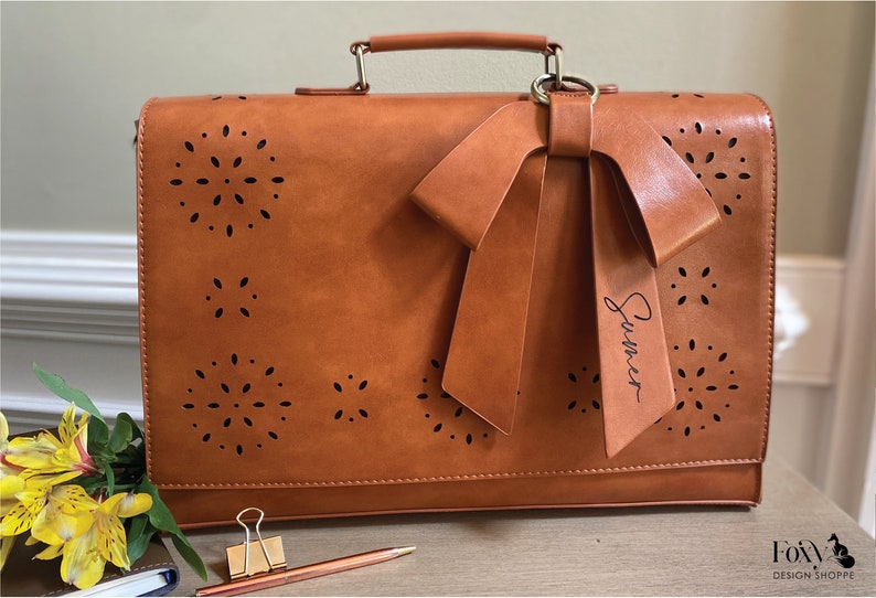 Tan leather laptop bag for women with bow and eyelet cutout detail. Custom leather laptop bag for women. Personalized vegan leather satchel for women. New job gift for woman. Graduation gift for woman. Custom gift for professional woman.