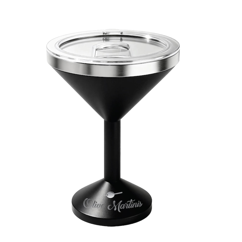 May include: A matte black martini glass with a stainless steel rim and a clear plastic lid. The base features a white graphic of an olive on a toothpick and the text Olive Martinis engraved in a cursive script font on the front of the stand.