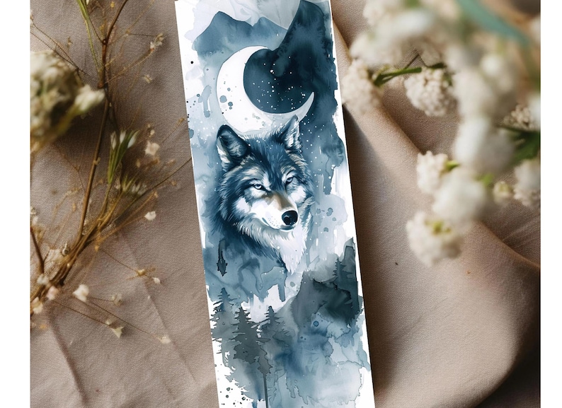 May include: A watercolor bookmark featuring a wolf with a crescent moon and starry sky. The design incorporates shades of blue and gray, with a forest scene at the bottom. The bookmark is a vertical rectangle.