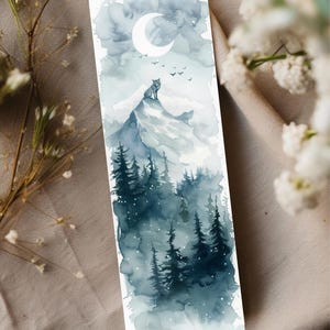May include: Watercolor bookmark featuring a wolf on a mountain peak under a crescent moon. The landscape includes dark blue evergreen trees and a cloudy sky. The bookmark is a vertical rectangle.