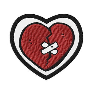 May include: A red heart with a white bandage over a crack, surrounded by a white outline and a black border.