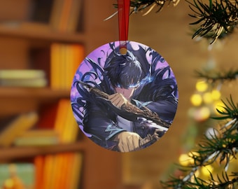 May include: Round ceramic ornament featuring a detailed anime illustration. The artwork depicts a character with dark hair, blue eyes, and a determined expression, holding a weapon. The ornament has a red ribbon for hanging and is set against a blurred background.