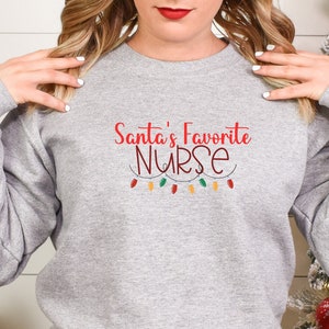 Santa's Favorite Nurse Sweater Christmas Nurse Sweater Christmas Gifts for Nurse Funny Nurse Sweater Christmas 2023 Nurse Gift RN Christmas