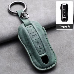 May include: A sage green leather key fob cover with a silver key ring. The cover has three buttons and a keyhole cutout. A small image of a car key is in the upper right corner with the text "Type A".