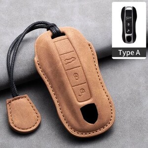 May include: A tan leather car key case with a black cord and a small matching tag. The case has embossed buttons and a cutout. A small image of a car key is in the upper right corner, labeled "Type A".