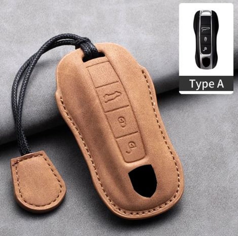 May include: A tan leather car key case with a black cord and a small matching tag. The case has embossed buttons and a cutout. A small image of a car key is in the upper right corner, labeled "Type A".