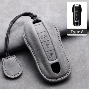May include: A gray leather key fob cover with a black lanyard and a matching tag. The cover has embossed buttons and a cutout. A small image of a key fob is in the upper right corner, labeled "Type A".