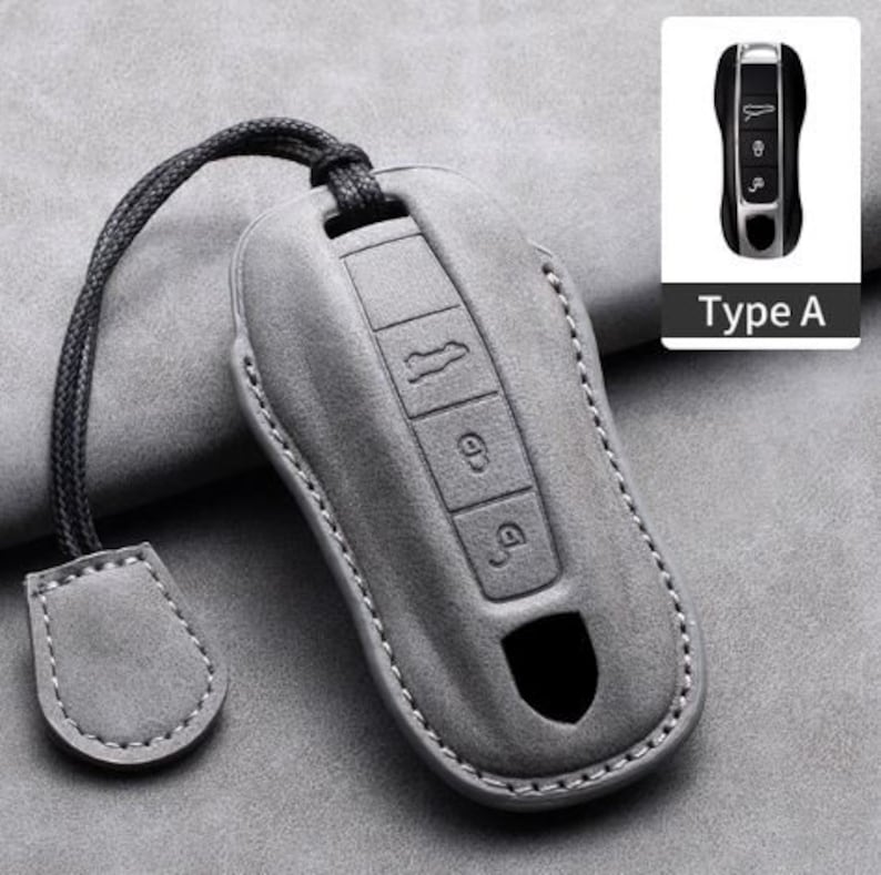 May include: A gray leather key fob cover with a black lanyard and a matching tag. The cover has embossed buttons and a cutout. A small image of a key fob is in the upper right corner, labeled "Type A".