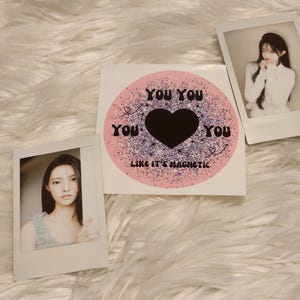 May include: A pink and white sticker with a black heart and the text "You You You Like It's Magnetic".