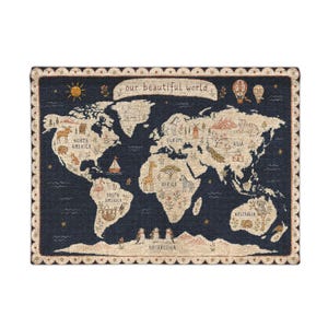 May include: A rectangular wall hanging featuring a dark blue world map with the text "our beautiful world" at the top. The map displays continents in a light beige tone, decorated with small illustrations of animals, trees, and landmarks.