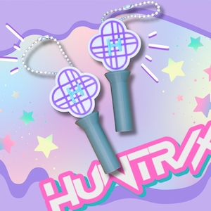 May include: Two light blue and white clover-shaped keychains with the letter "H" in the center. The keychains have a light blue handle and a silver chain. The background is a pastel gradient with stars and the text "HUNTXRX".