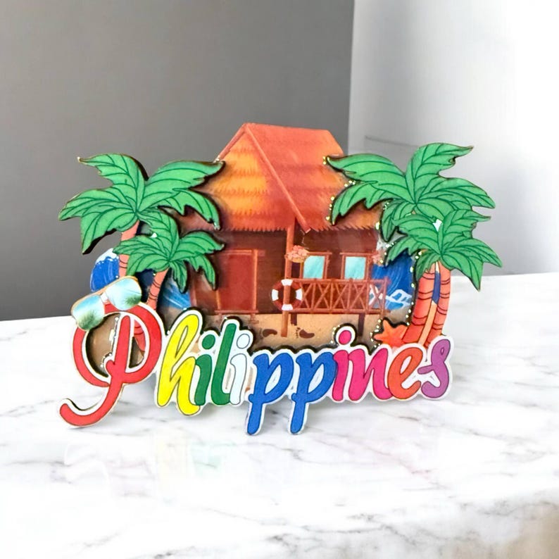 May include: A colorful wooden souvenir of the Philippines featuring a beach hut, palm trees, and the word "Philippines" in rainbow letters.