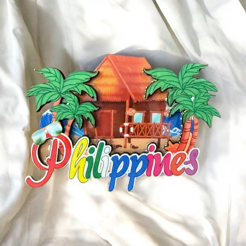 May include: A colorful wooden souvenir from the Philippines featuring a beach hut, palm trees, and the word "Philippines" in rainbow letters.