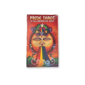 May include: A box for a Pride Tarot deck with a colorful illustration of a sun face with a rainbow coming out of its mouth. The text on the box reads "Pride Tarot A Collaborative Deck".
