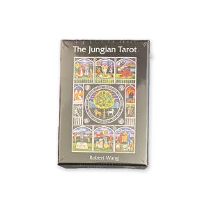 May include: A deck of "The Jungian Tarot" cards by Robert Wang. The card box is dark gray with colorful illustrations of figures and scenes. The title and author's name are in white text.