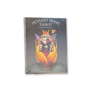 May include: A sealed deck of "Deviant Moon Tarot" cards by Patrick Valenza. The box features a dark background with an illustration of a figure with a split face, surrounded by a fiery, floral design. The title is in a stylized font.