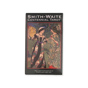 May include: A rectangular black box featuring the "Smith-Waite Centennial Tarot" title. The box art depicts two women in flowing dresses, with text that reads "Includes Four Samples of Pixie's Non-Tarot Art."