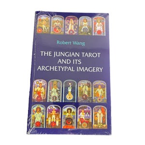 May include: A purple book titled "The Jungian Tarot and Its Archetypal Imagery" by Robert Wang. The cover features a collage of colorful tarot cards with images of people and symbols.