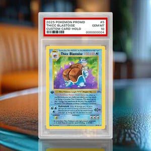 May include: A graded 2025 Pokemon promo custom holographic trading card titled Thicc Blastoise, encased in a clear plastic slab. The card features a blue character with a brown shell, 100 HP, and text including Thicc Pokemon Power: Dunk Dance.