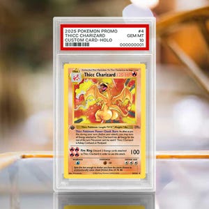 May include: A graded 2025 Pokemon promo Thicc Charizard custom holo card in a clear plastic slab. The label reads 2025 POKEMON PROMO THICC CHARIZARD CUSTOM CARD-HOLO #4 GEM MT 10. The card features a yellow border and a fire-type dragon illustration.